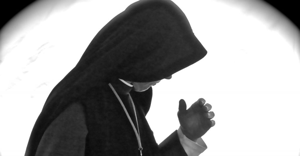 Nun in deep prayer, religious life